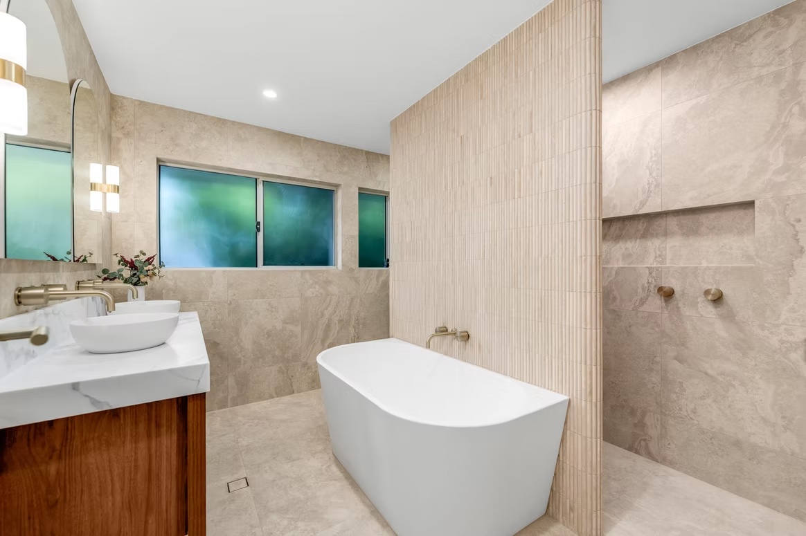 Travertine-look bathroom with pencil feature wall